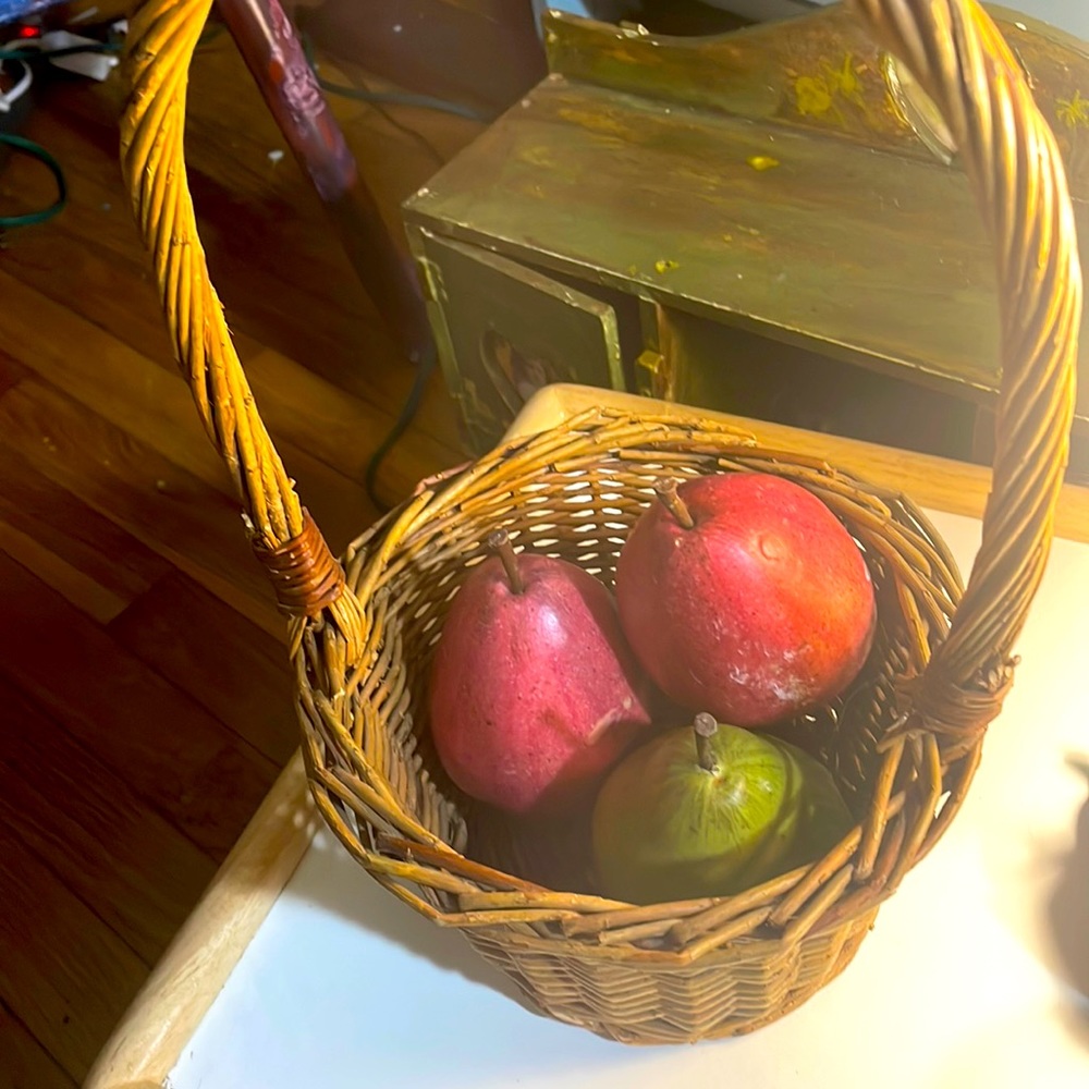 Vintage basket with faux realistic pears, two red , one green.